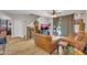 Living room with wood flooring, a leather sofa set, and a view of the backyard pool at 10613 E Knowles Ave, Mesa, AZ 85209