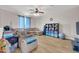 Comfortable living room with a sectional sofa, ceiling fan, and organized shelving unit at 10613 E Knowles Ave, Mesa, AZ 85209