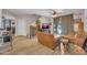 Cozy living room with wood floors, leather seating, and open access to the staircase at 10613 E Knowles Ave, Mesa, AZ 85209