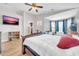 Large bedroom featuring hardwood floors, TV, a shower room, and a sitting area, enhancing comfort and style at 10613 E Knowles Ave, Mesa, AZ 85209