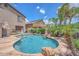 Gorgeous backyard featuring a private pool with a rock waterfall feature and desert landscaping at 10613 E Knowles Ave, Mesa, AZ 85209