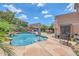 Gorgeous backyard featuring a private pool, rock waterfall and meticulously landscaped yard, perfect for relaxing or entertaining at 10613 E Knowles Ave, Mesa, AZ 85209
