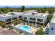 Aerial view showcases community pool, outdoor seating, landscaping, and modern building architecture at 1111 E Missouri Ave # 9, Phoenix, AZ 85014