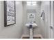 Powder room featuring a pedestal sink, modern mirror, and decor at 1111 E Missouri Ave # 9, Phoenix, AZ 85014