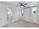 Bedroom with neutral color scheme, window, carpet, ceiling fan, ensuite bathroom, and sliding door closet at 1111 E Missouri Ave # 9, Phoenix, AZ 85014