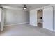 Spacious bedroom features neutral colors, carpet, ceiling fan and sliding barn door access to the en-suite bathroom at 1111 E Missouri Ave # 9, Phoenix, AZ 85014