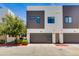 Modern townhome with attached garage, unique design elements, and well-maintained landscaping at 1111 E Missouri Ave # 9, Phoenix, AZ 85014