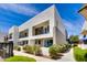 Modern condo building with private balconies, beautiful landscaping, and ample outdoor space on a sunny day at 1111 E Missouri Ave # 9, Phoenix, AZ 85014