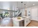 Kitchen featuring a central island and sink with stainless steel appliances and view into the living room at 1111 E Missouri Ave # 9, Phoenix, AZ 85014