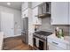 Close-up of kitchen with stainless steel appliances, including a gas range, and modern gray backsplash at 1111 E Missouri Ave # 9, Phoenix, AZ 85014