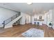 Spacious living area with hardwood floors, a modern staircase, and a view into the bright kitchen at 1111 E Missouri Ave # 9, Phoenix, AZ 85014