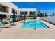 Inviting community pool with lounge chairs, umbrellas, and well-maintained surrounding landscaping at 1111 E Missouri Ave # 9, Phoenix, AZ 85014