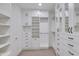 Walk-in closet featuring custom white cabinets and drawers providing lots of functional storage at 1111 E Missouri Ave # 9, Phoenix, AZ 85014