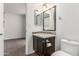 Bathroom vanity with dark wood cabinets, mosaic backsplash, and nearby toilet at 11290 E Poinsettia Dr, Scottsdale, AZ 85259