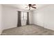 Bedroom featuring gray carpet, sliding closet doors, and neutral decor at 11290 E Poinsettia Dr, Scottsdale, AZ 85259