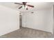 Bright bedroom with neutral carpet, ceiling fan, and a walk-in closet at 11290 E Poinsettia Dr, Scottsdale, AZ 85259