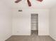 Neutral bedroom with ceiling fan and walk-in closet with shelving at 11290 E Poinsettia Dr, Scottsdale, AZ 85259