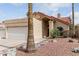 Charming single-story home featuring a red tile roof, desert landscaping, and an attached two-car garage at 11290 E Poinsettia Dr, Scottsdale, AZ 85259