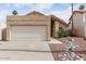 Single story house with a two-car garage and desert landscaping for low maintenance living at 11290 E Poinsettia Dr, Scottsdale, AZ 85259