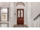 Inviting foyer with a decorative wood front door, neutral walls, and tile flooring at 11290 E Poinsettia Dr, Scottsdale, AZ 85259