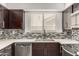 Close-up of kitchen featuring stainless steel appliances, sleek countertops, and mosaic backsplash at 11290 E Poinsettia Dr, Scottsdale, AZ 85259