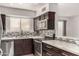 Kitchen showcasing modern appliances, sleek countertops, tile backsplash, and dark cabinetry at 11290 E Poinsettia Dr, Scottsdale, AZ 85259