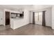 Open-concept living area with tile flooring, breakfast bar, and abundant natural light from the window at 11290 E Poinsettia Dr, Scottsdale, AZ 85259