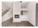 Spacious living room with a white brick fireplace, stairs, and neutral colors at 11290 E Poinsettia Dr, Scottsdale, AZ 85259