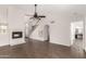 Bright living room with tile flooring, a fireplace, and an open layout leading to the kitchen at 11290 E Poinsettia Dr, Scottsdale, AZ 85259