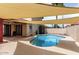 Enjoy the backyard pool with shade structure and covered patio, perfect for outdoor living at 11290 E Poinsettia Dr, Scottsdale, AZ 85259