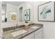 Modern bathroom featuring double sinks, granite countertops, and decorative art at 11858 E Cliffrose Ln, Florence, AZ 85132