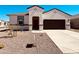 Charming single-Gathering home with a dark-colored garage door, neutral-colored exterior, and low-maintenance landscaping at 11858 E Cliffrose Ln, Florence, AZ 85132