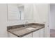 Bathroom vanity featuring granite counters, white cabinets, and a large mirror at 12232 E Agave Ln, Florence, AZ 85132