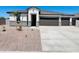 Charming single-story home with a well-manicured front yard and attached two-car garage in a suburban neighborhood at 12232 E Agave Ln, Florence, AZ 85132