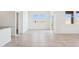 Bright living room with neutral tile flooring, large windows, and sliding glass door at 12232 E Agave Ln, Florence, AZ 85132