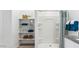 A bright bathroom with a white shower and shelves displaying neatly folded towels, baskets, and decor at 12235 E Agave Ln, Florence, AZ 85132