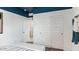 A bedroom showcasing white walls with a blue ceiling accent and convenient sliding closet doors at 12235 E Agave Ln, Florence, AZ 85132