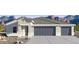 Charming single-story home with a three-car garage and desert landscaping against a backdrop of majestic mountains at 12235 E Agave Ln, Florence, AZ 85132