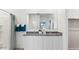 Bathroom with double sink vanity, granite countertop, and a large mirror at 12247 E Agave Ln, Florence, AZ 85132