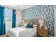 Beautiful bedroom featuring cactus-print wallpaper, a cozy rattan headboard, and stylish nightstands at 12247 E Agave Ln, Florence, AZ 85132