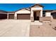Charming single-story home featuring a two-car garage and a desert-landscaped front yard at 12247 E Agave Ln, Florence, AZ 85132