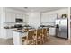 Modern kitchen with stainless steel appliances, granite countertops, and a spacious island with seating for four at 12247 E Agave Ln, Florence, AZ 85132