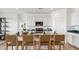 Well-appointed kitchen featuring white cabinetry, granite countertops, and a breakfast bar with stylish woven stools at 12247 E Agave Ln, Florence, AZ 85132