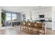 Open-concept kitchen flowing into a dining area, featuring modern appliances, and barstool seating at the island at 12247 E Agave Ln, Florence, AZ 85132