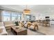 Spacious living room with a seamless open floor plan to a dining area and kitchen, creating a welcoming atmosphere at 12247 E Agave Ln, Florence, AZ 85132