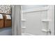 Clean white shower/tub combination with integral shelves, chrome fixtures, and decorative towels at 12247 E Agave Ln, Florence, AZ 85132