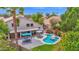 Stunning backyard featuring a pool, patio with dining area, and lush tropical landscaping at 1292 N Renee Ave, Gilbert, AZ 85234