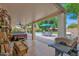 Spacious covered patio leading to a backyard with a pool, hot tub, and lush landscaping at 1292 N Renee Ave, Gilbert, AZ 85234
