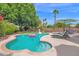 Inviting backyard featuring a sparkling pool, lush landscaping, and comfortable lounge chairs for ultimate relaxation at 1292 N Renee Ave, Gilbert, AZ 85234