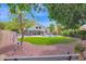 Serene backyard featuring lush green lawn, a sparkling pool, and a cozy patio area, ideal for outdoor living at 1292 N Renee Ave, Gilbert, AZ 85234